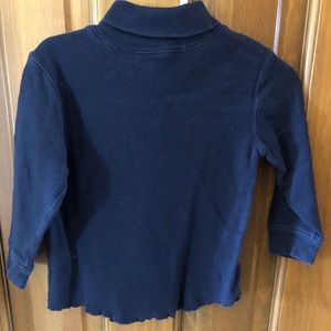 Navy mock turtleneck long sleeved shirt.